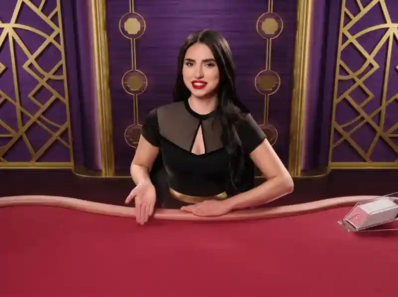 SkyCrown Casino live baccarat dealer at a felt table with a card shoe